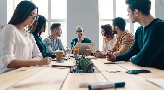Team discussing ideas in a modern office meeting.
