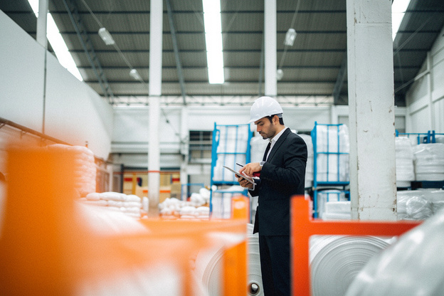 Business risk assessment inspection being carried out in an industrial warehouse