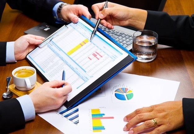 Reviewing workplace safety statistics and risk assessment documents on a tablet